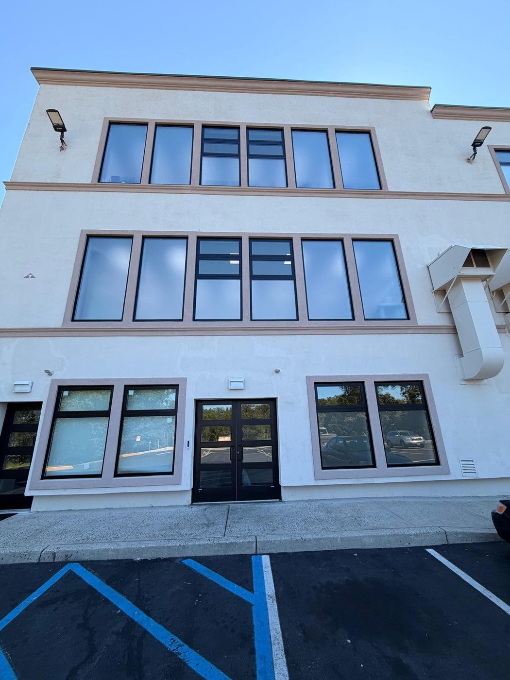 Three-storey elevation with commercial glazing at ground level &mdash; Lakewood, New Jersey