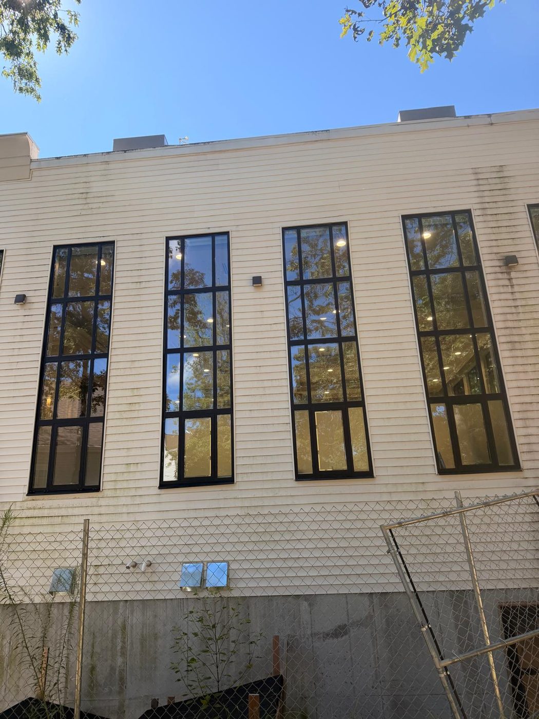 Tall aluminum windows with divided lites on the adjoining elevation &mdash; Lakewood, New Jersey