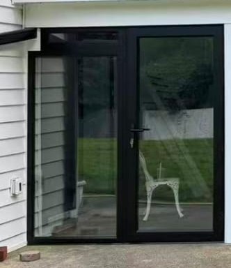 Black-framed glass doors enclosing the ground level under the deck sunroom in Manalapan, NJ