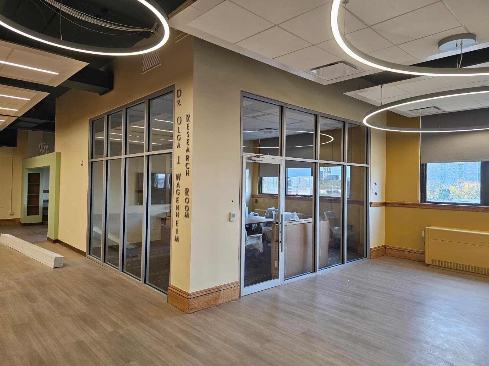 Corner glass office partition with tempered glass lites and slim aluminum mullions at the Newark Public Library, Newark NJ