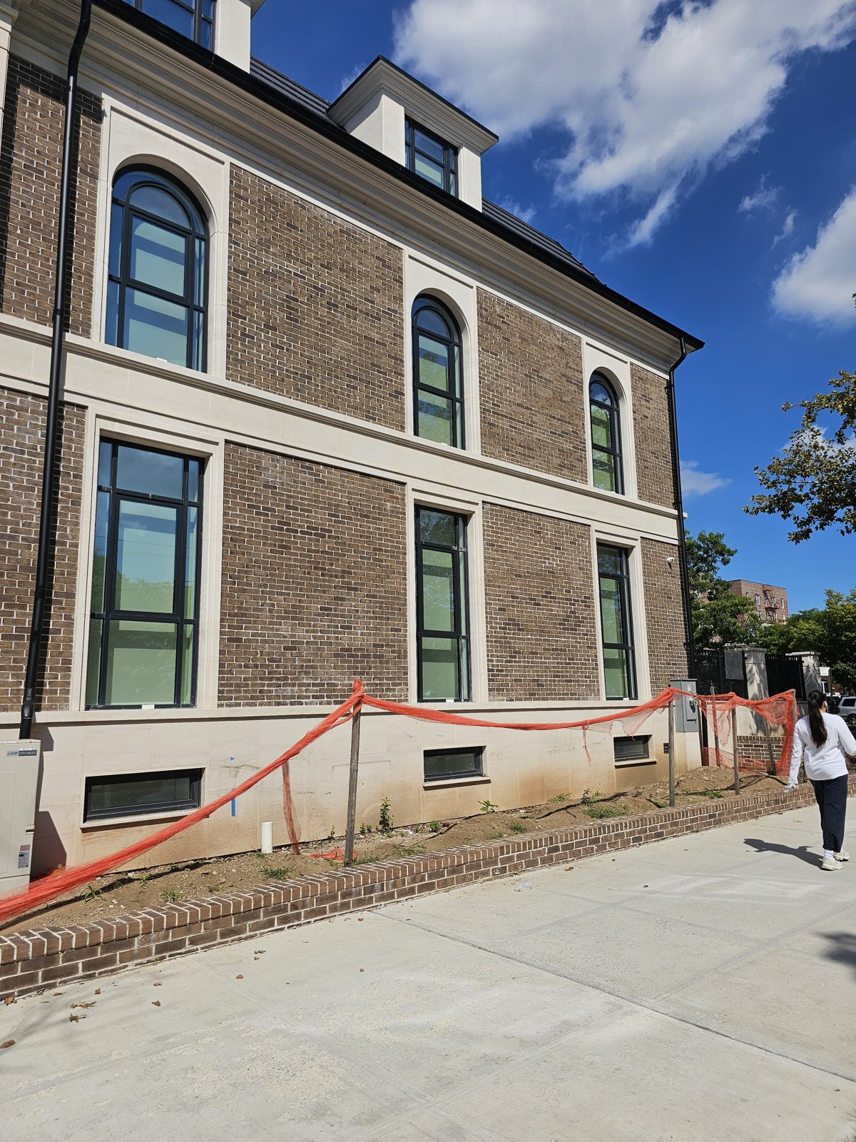 Brick and limestone side elevation with custom arched Reynaers windows, Ocean Parkway, Brooklyn