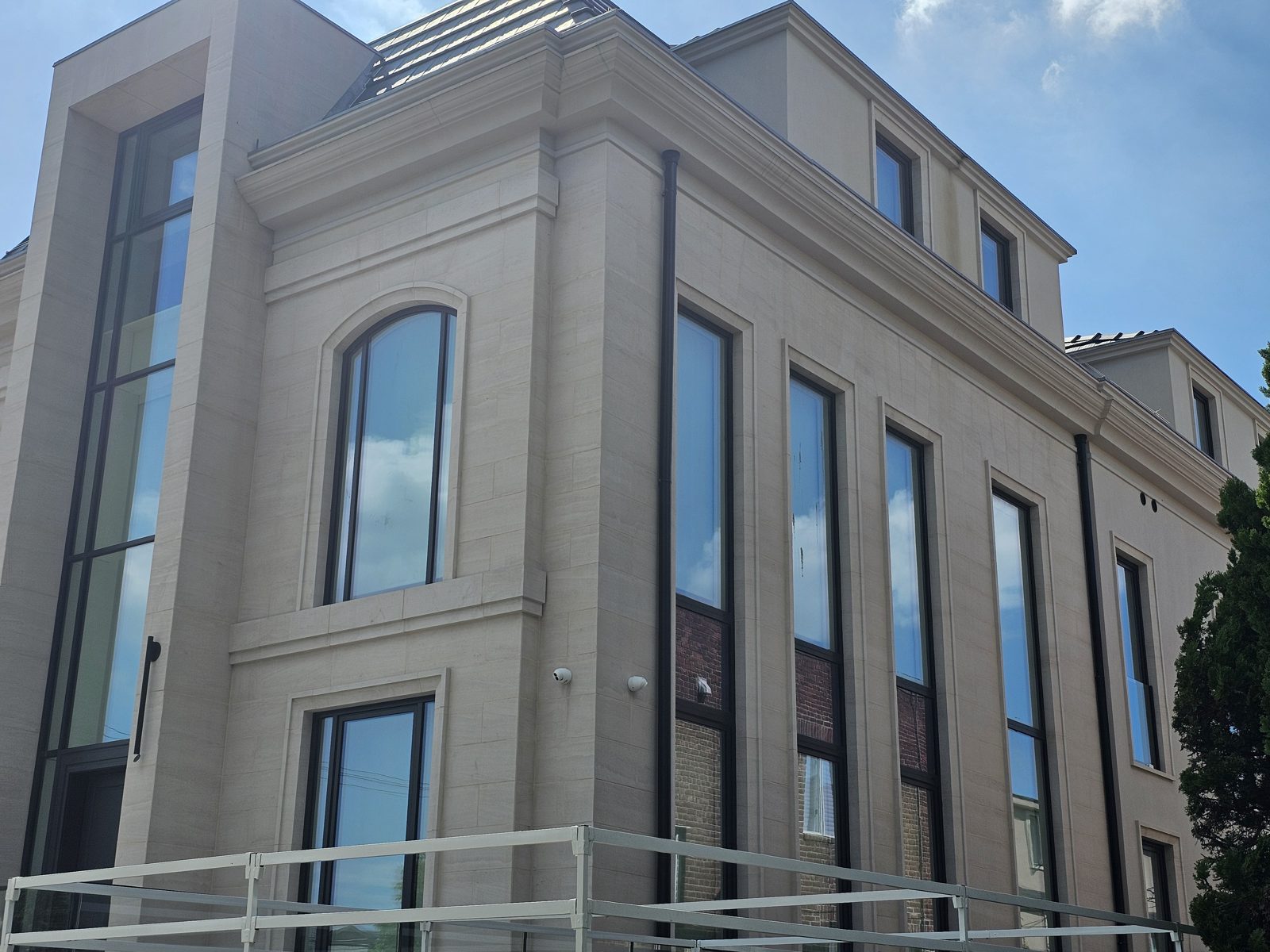 Tall slot windows and arched window on the limestone elevation