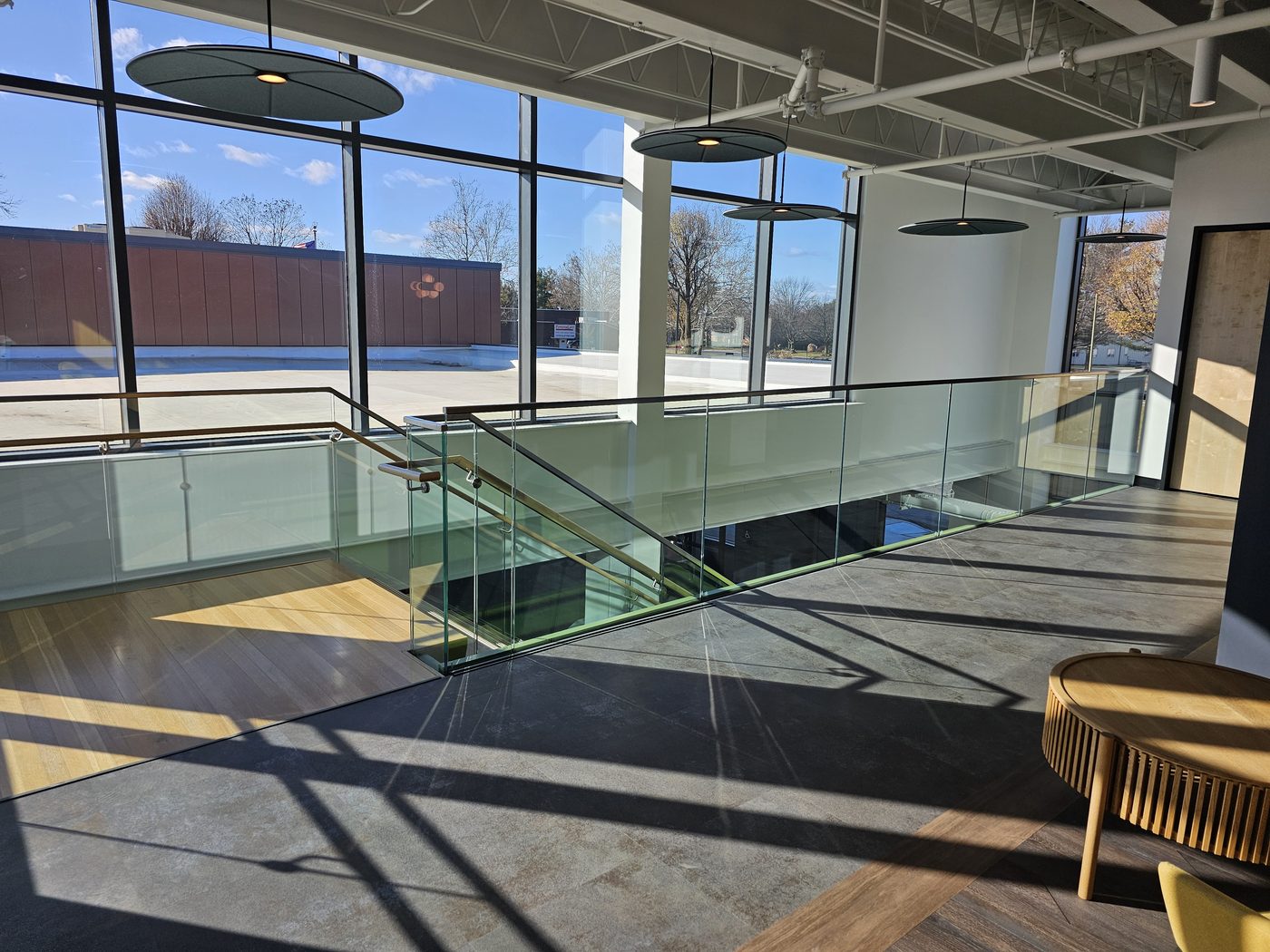 Mezzanine edge with Q-railing base-shoe glass guard and cap rail overlooking the lobby, UGI Utilities, Bethlehem, PA