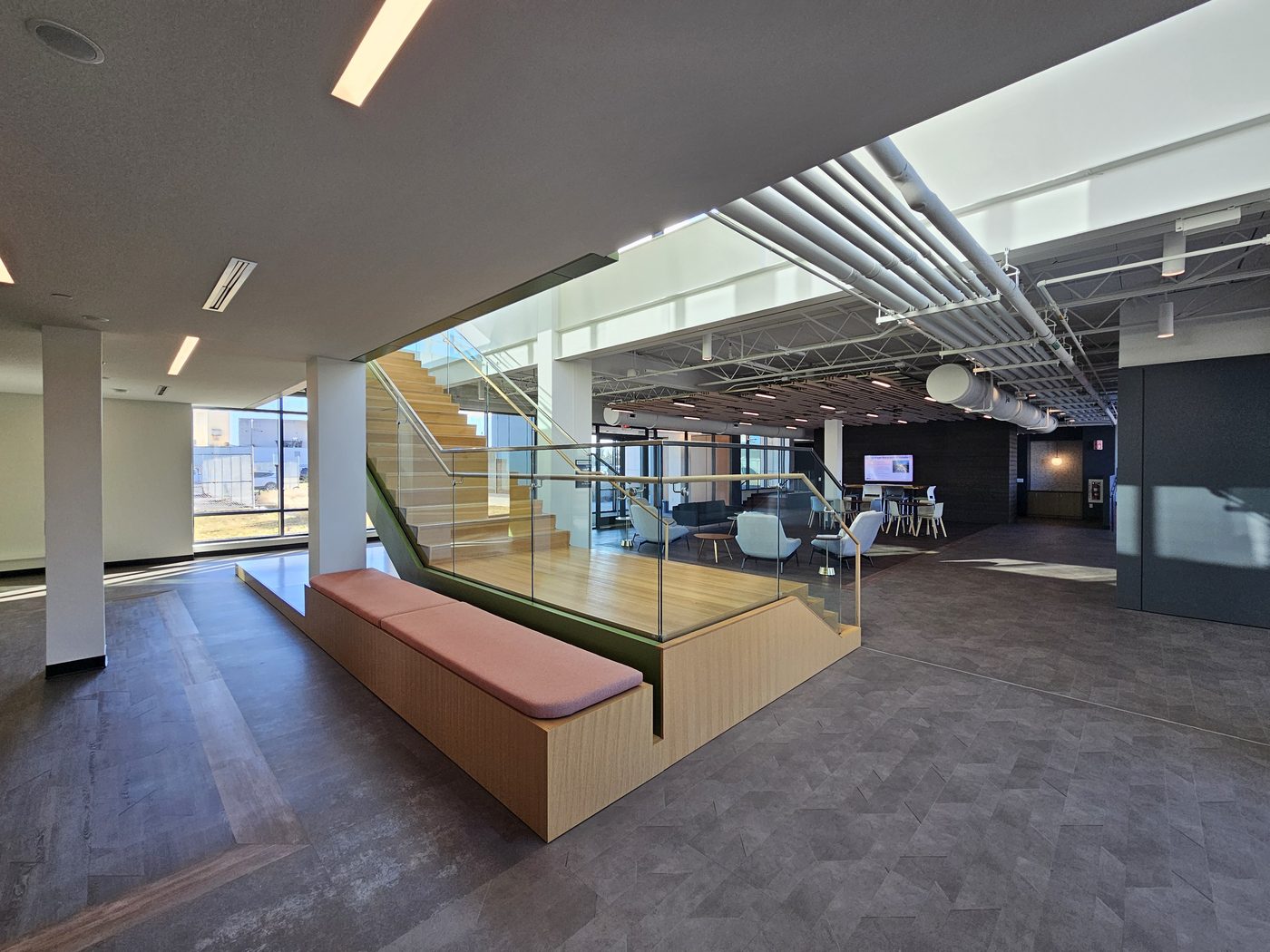 Lobby view of the staircase with glass railings and stepped seating platform at UGI Utilities, Bethlehem, PA