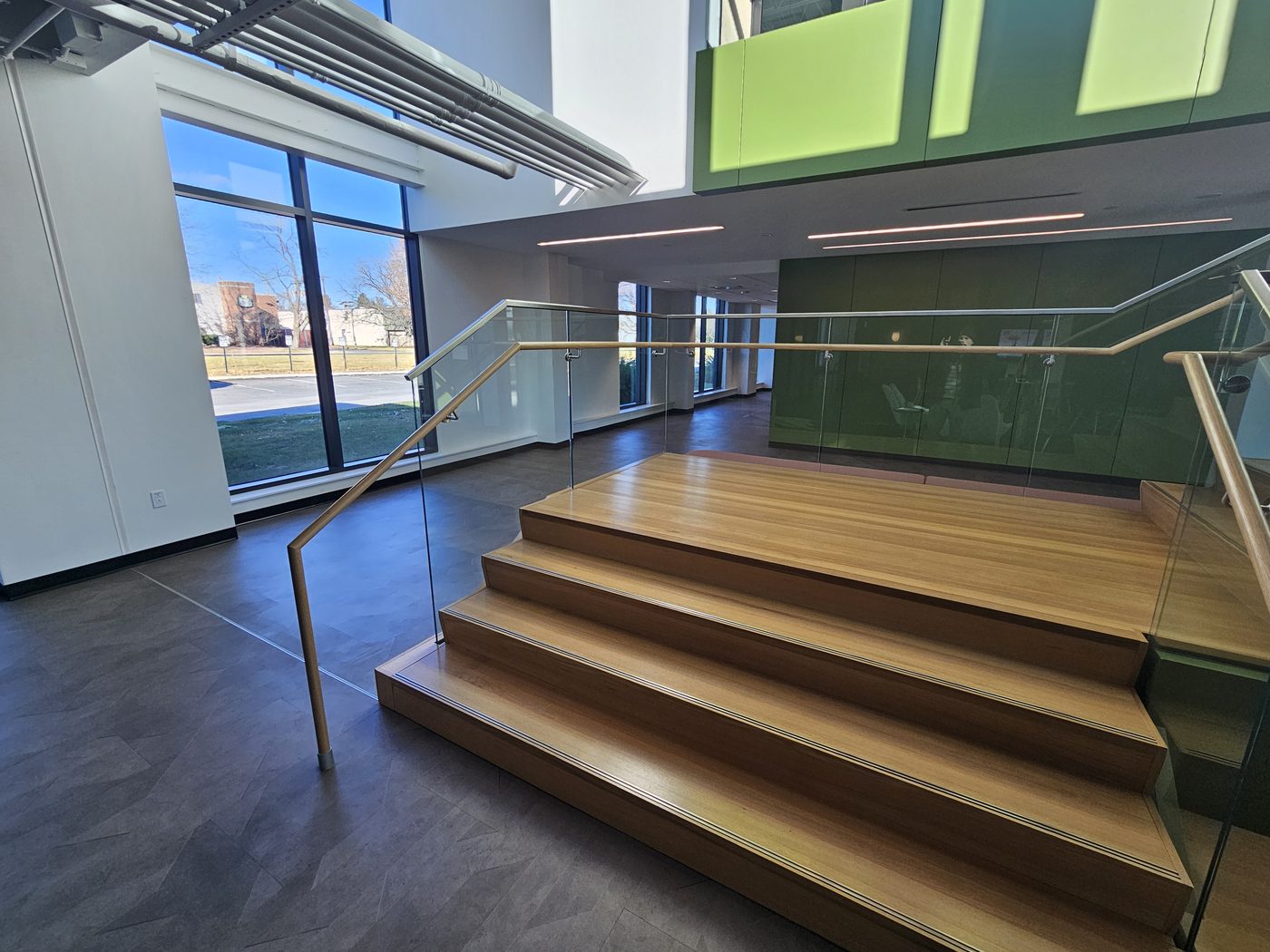 Stepped platform and stair with glass guards and wood handrail on stainless brackets, UGI Utilities, Bethlehem, PA