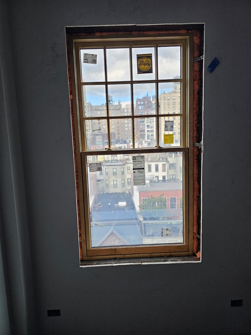 A tall opening with a heavily divided upper sash, reproducing the original light pattern &mdash; Upper West Side, Manhattan