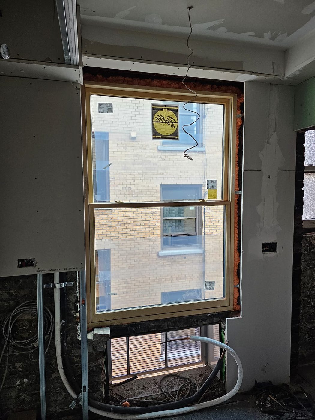 Installation in progress, with drywall returns being formed around the new frame &mdash; Upper West Side, Manhattan