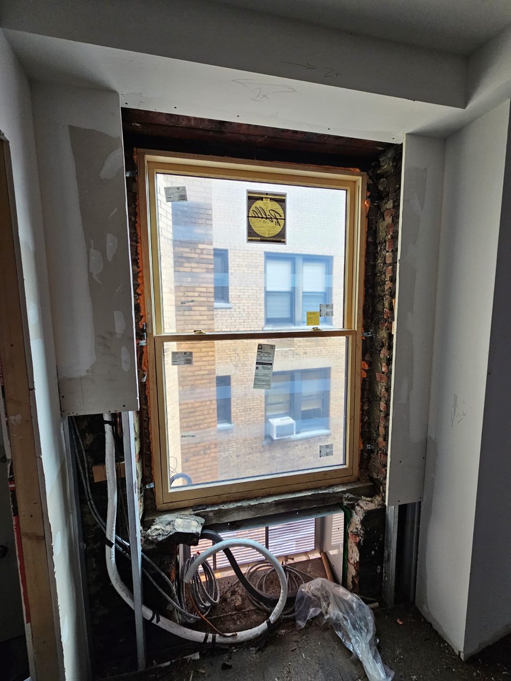The unit set in a stripped masonry opening - the point at which an old opening shows how far out of square it really is &mdash; Upper West Side, Manhattan