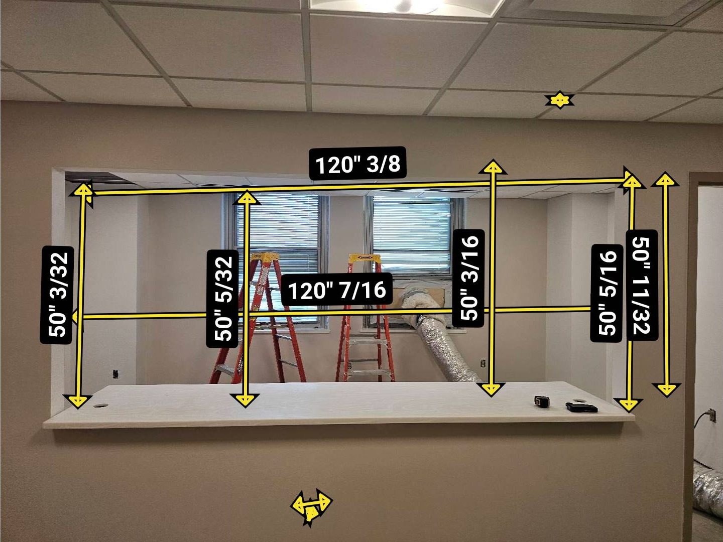 Reception counter opening at a VA hospital marked with field measurements: about 120 3/8 inches wide and 50 inches high, measured at several points