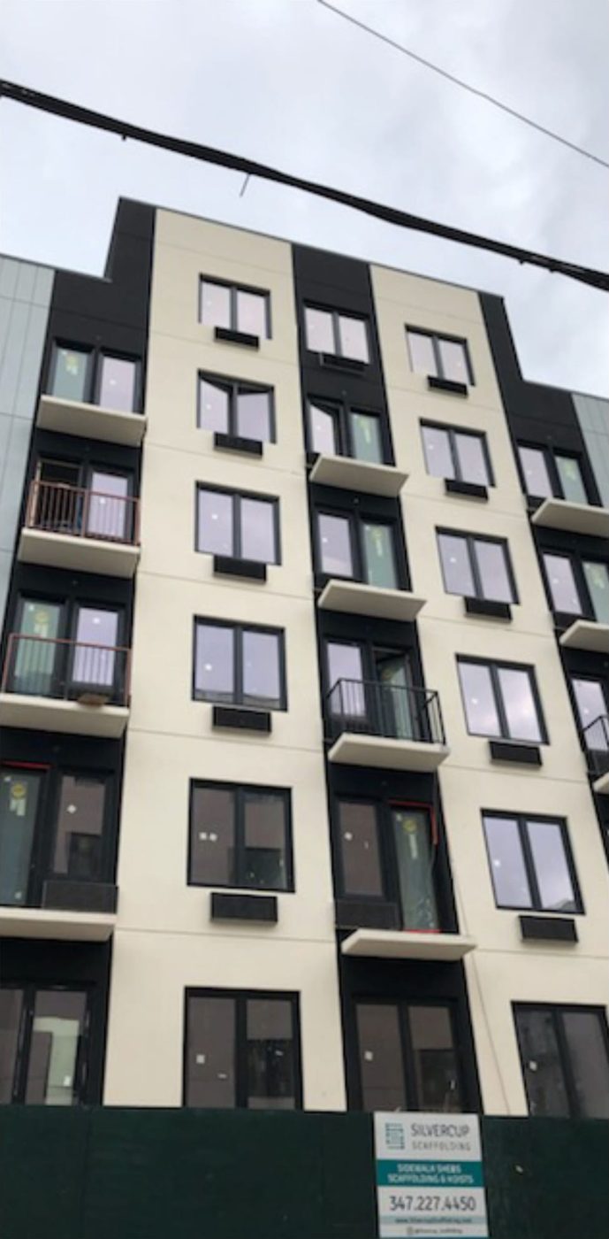Woodycrest Avenue elevation of The Elston with paired black uPVC windows and balcony doors on six floors