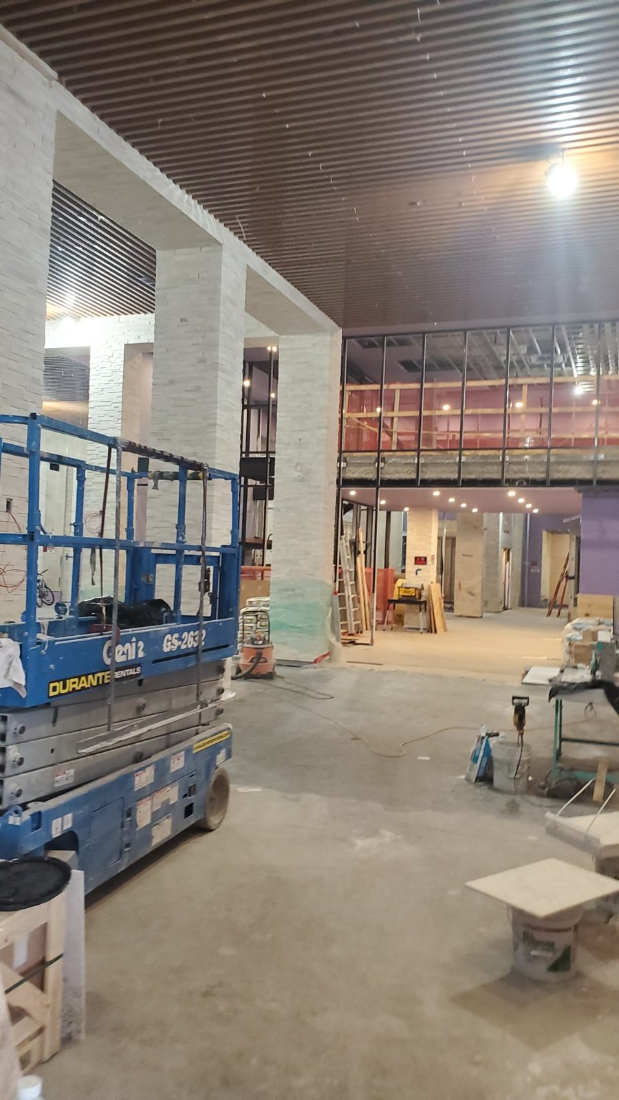 Black aluminum curtain wall at the mezzanine level of the main hall at World Spa, Brooklyn, during construction